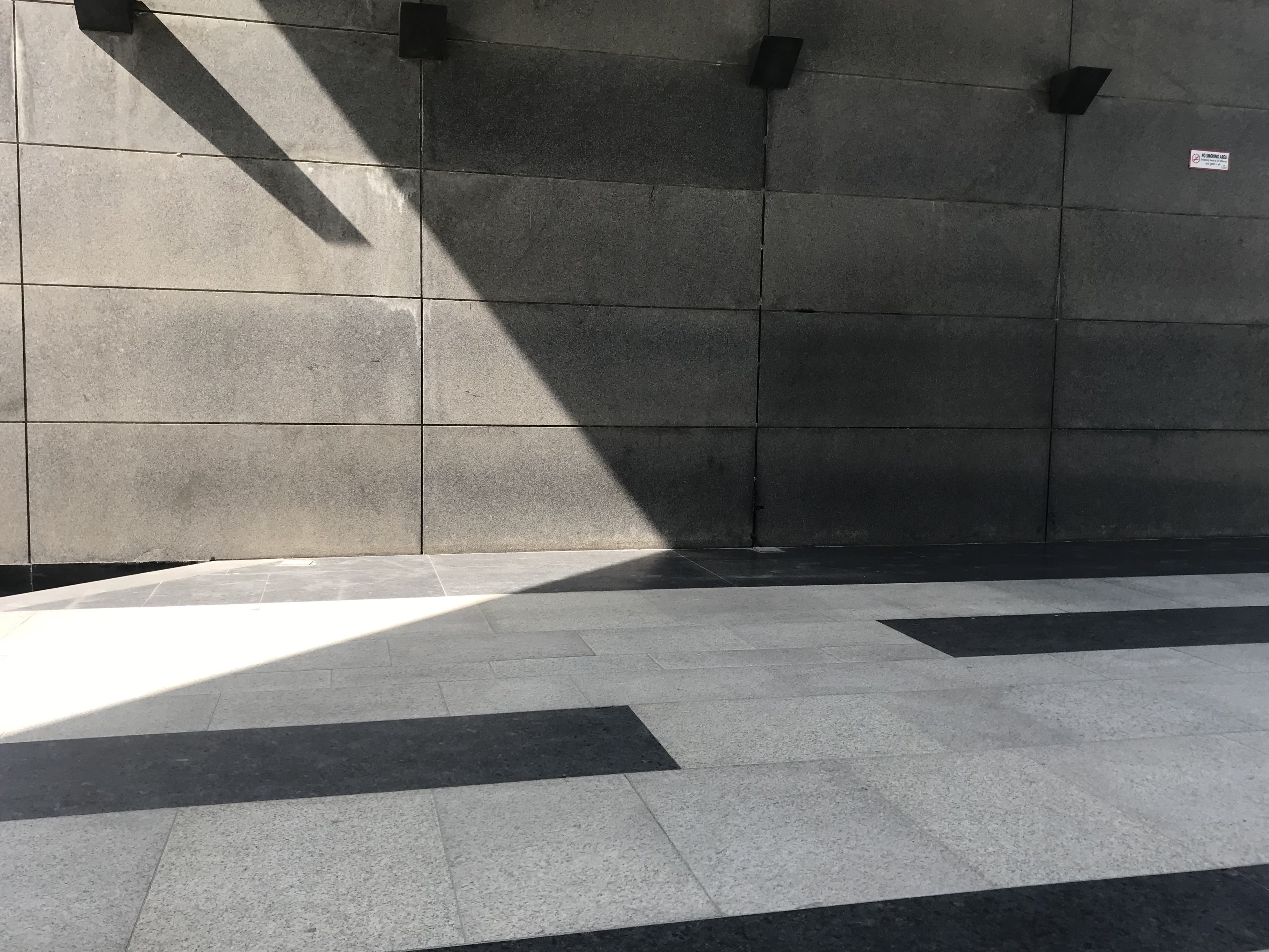 Modern looking tiled floor background with sunlight and shadow